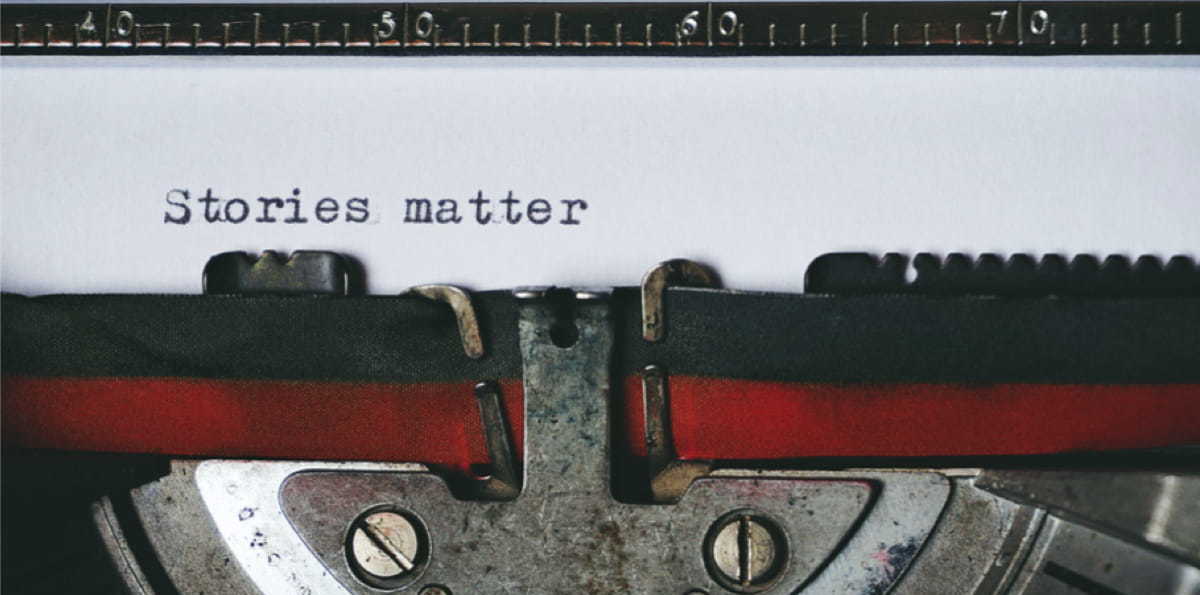 the words 'stories matter' typed on an old typewriter